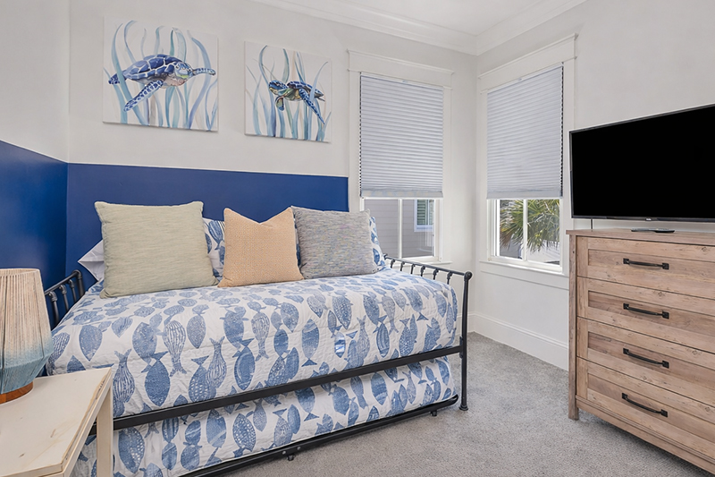 Twin bedroom with navy accent wall - Seaside Retreat